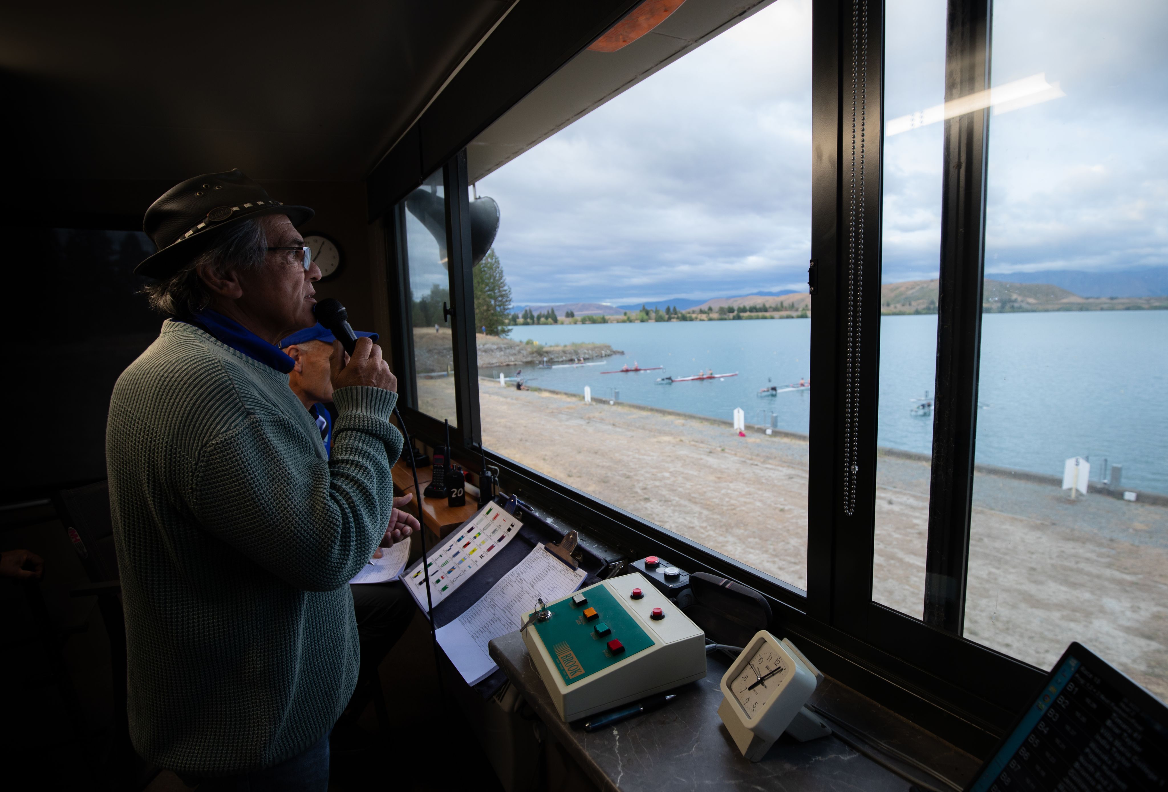 Justin Wall holds a microphone in the regattas starting tower