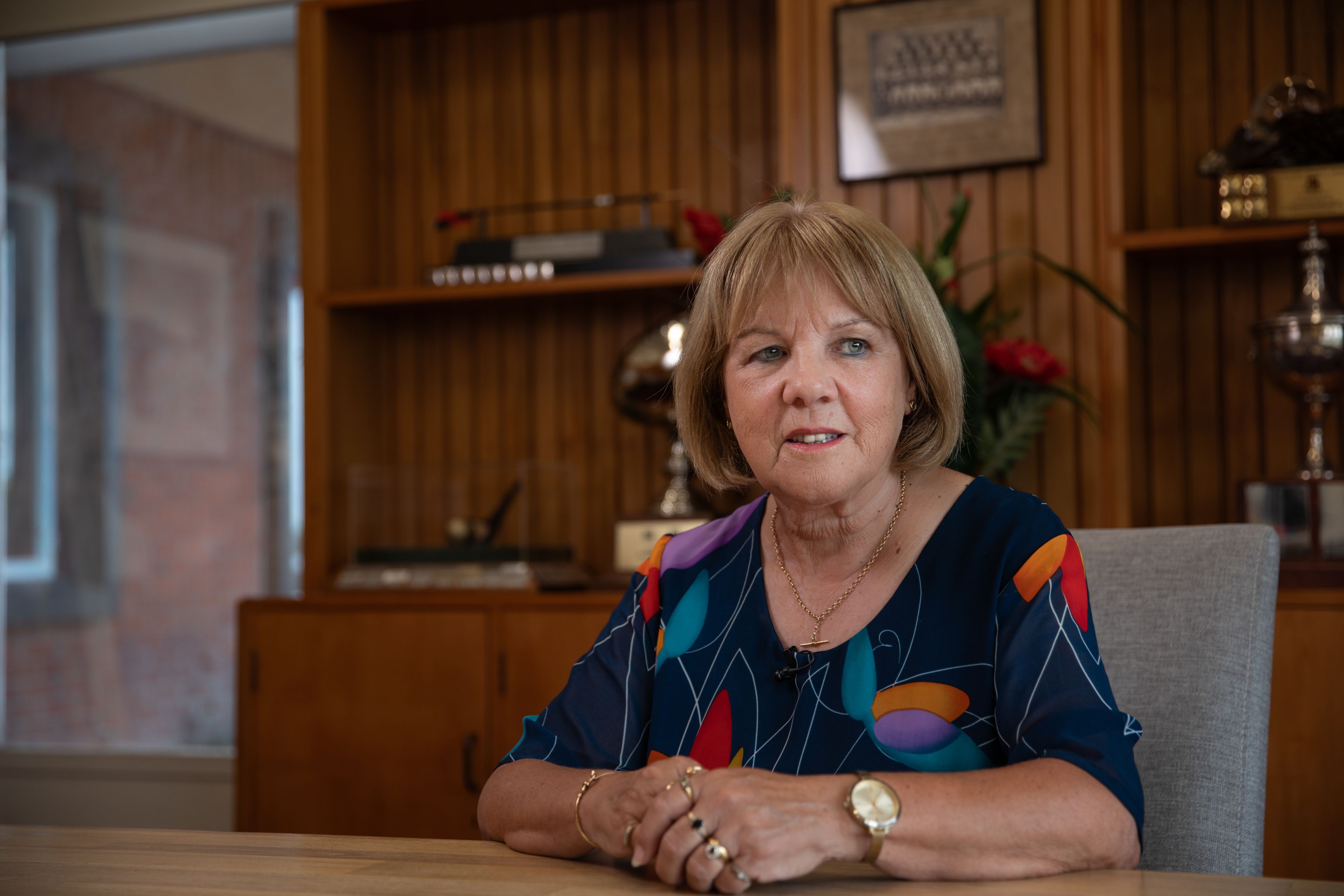 Susan Hassall sits at her desk